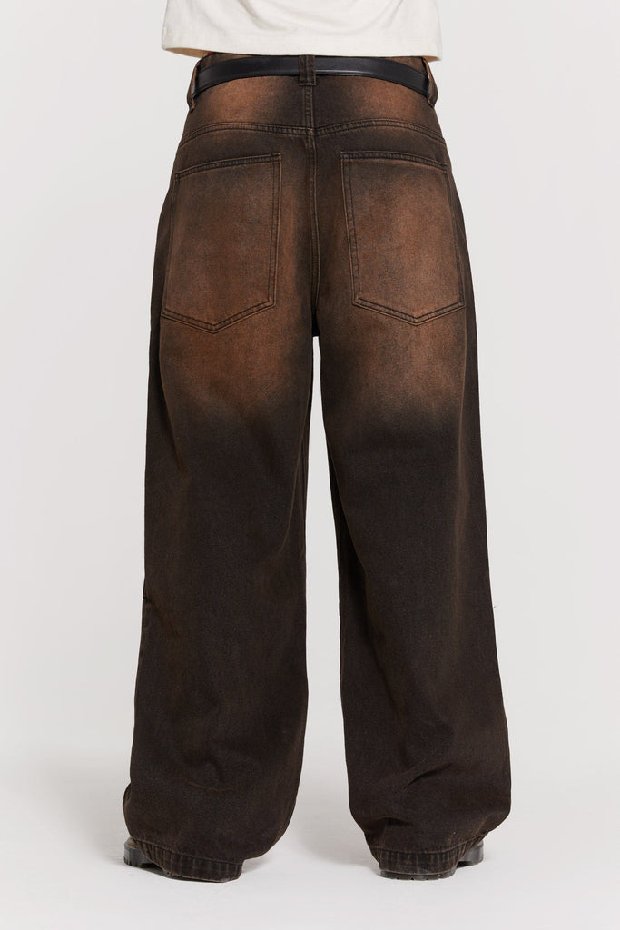 Male wearing vintage brown colossus fit jeans. 