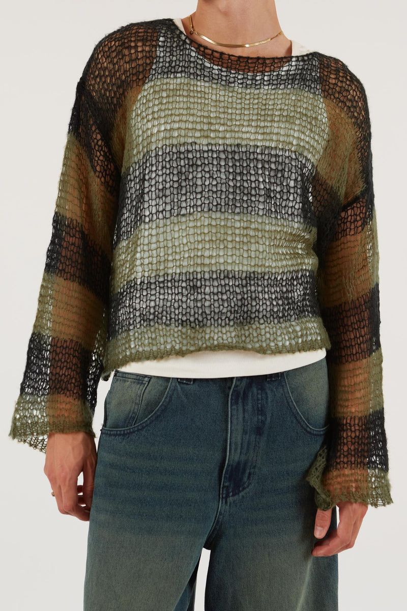 Male wearing Green & Black Stripe Knit Jumper. Styled with washed blue denim jeans. 