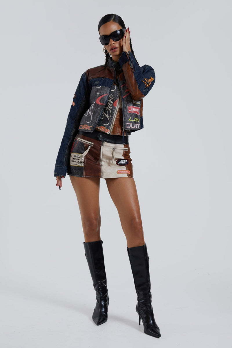 Female wearing denim PU zip up long sleeve moto jacket with embroidery detail. Styled with the matching motto mini skirt. 