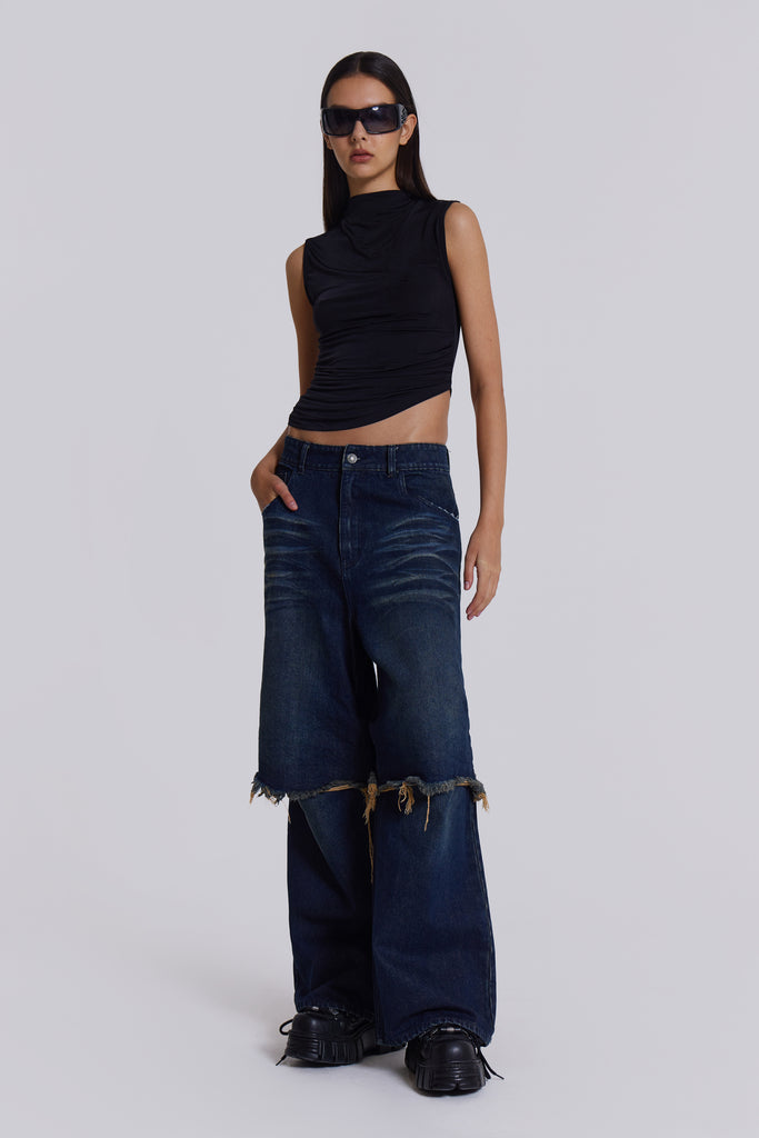  Female model wearing blue indigo baggy, loose fit denim jeans with a double layer effect. 