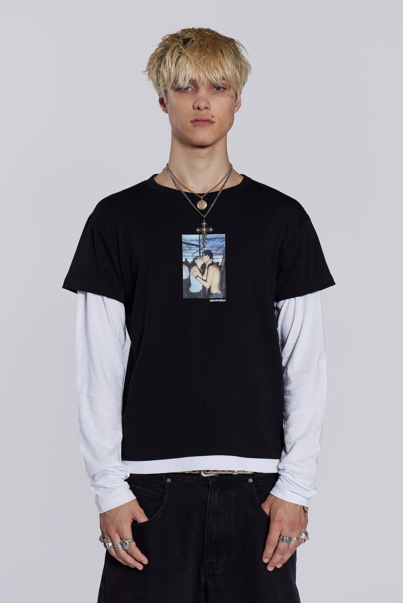 Man wearing graphic print double layer t-shirt, styled with black denim jeans/