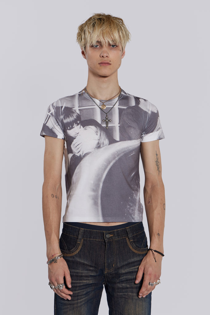 Male model wearing shrunken short sleeve t-shirt, with couple kissing graphic print.