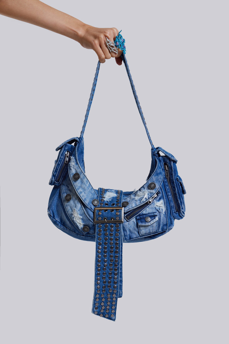 Complete your look with the Amoral Studded Shoulder Bag – crafted from a washed blue denim fabric, this shoulder bag features multi pockets, distressing detail and an XL belt buckle complete with hardware details.