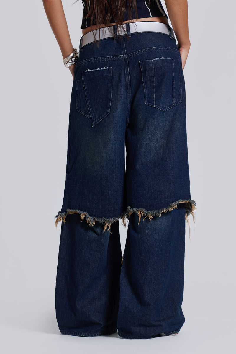  Female model wearing blue indigo baggy, loose fit denim jeans with a double layer effect.  
