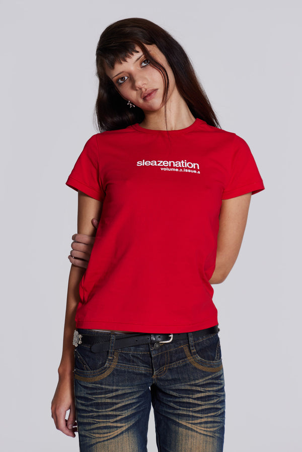 Female model wearing red shrunken short sleeve t-shirt, with Sleazenation printed graphic.