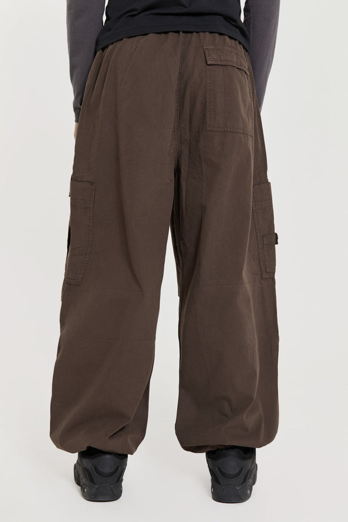 Unisex brown oversized fitted parachute style cargo trousers with six pocket styling. 