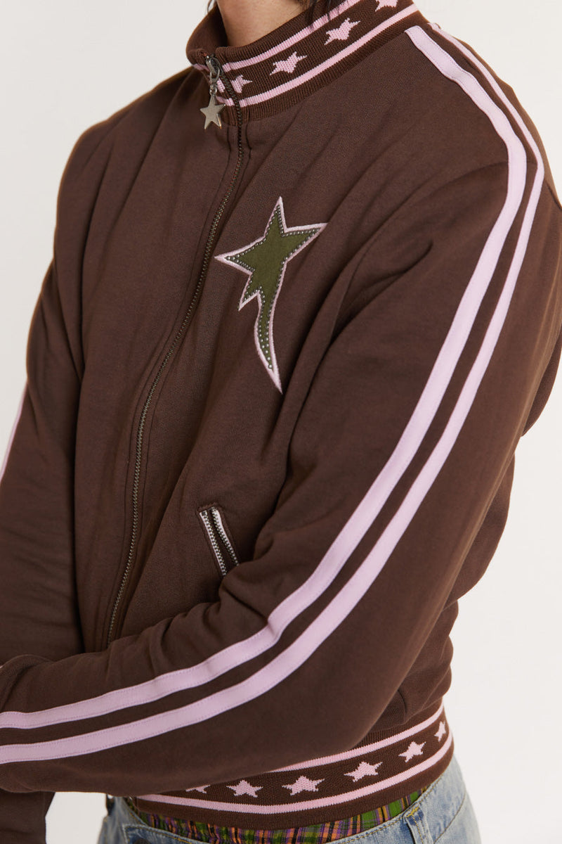 Male model wearing Brown & Pink Track Top with pink stripe detail. 