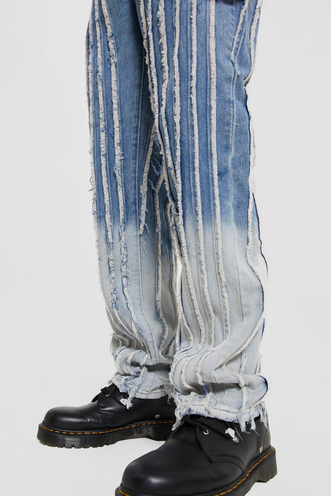 Close up of distressed straight leg blue jeans