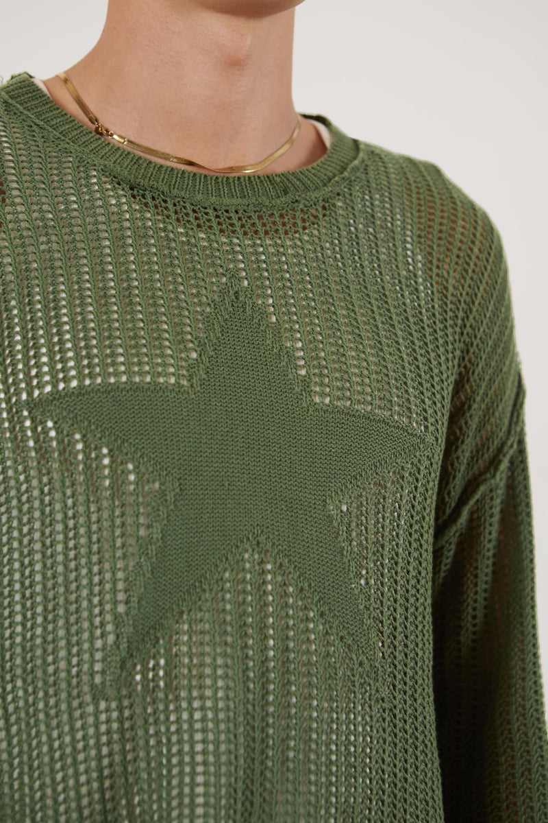 Male wearing Khaki Green Star Loose Knit Jumper.  Styled with blue oversized denim shorts.