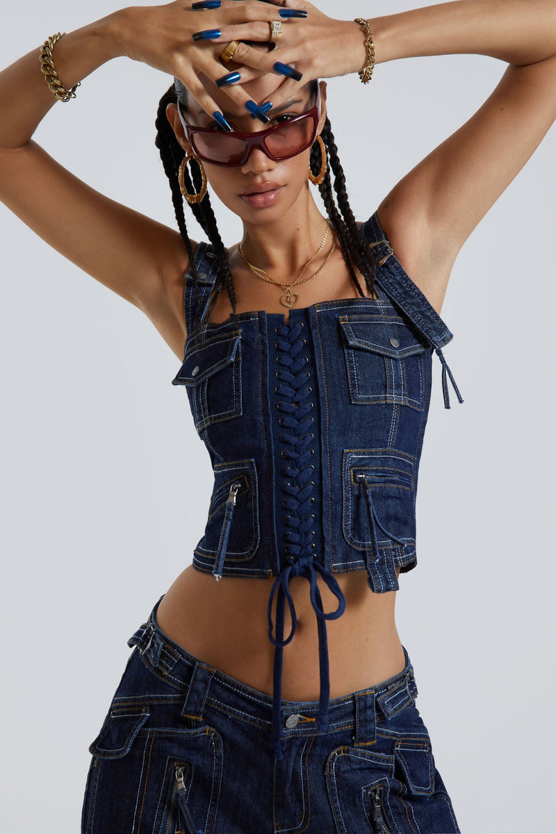 Female wearing indigo blue denim cargo style lace up corset top. Styled with the matching denim cargo trousers.  