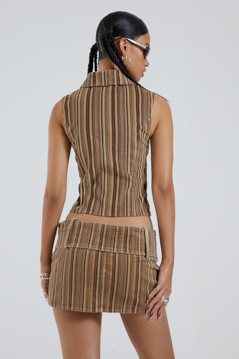 Female wearing brown cord collar detail sleeveless shell top with double ended zip.  Styled with the matching mini skirt. 