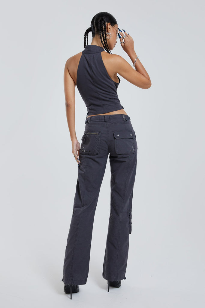 Female wearing vintage grey low rise slim fit cargo trousers. Styled with the matching cargo halterneck top. 