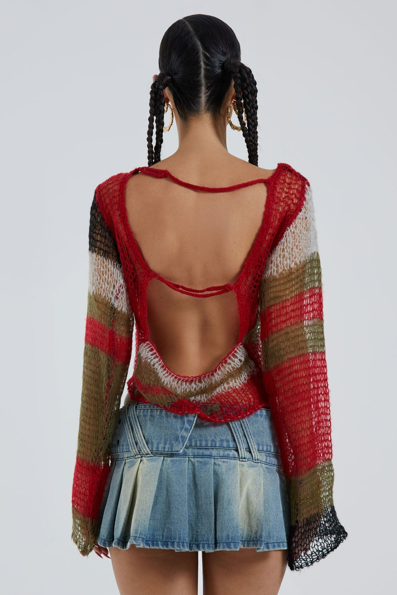 Female wearing multicoloured abstract fine knit long sleeve cropped jumper. Styled with the blue pleated denim mini skirt. 