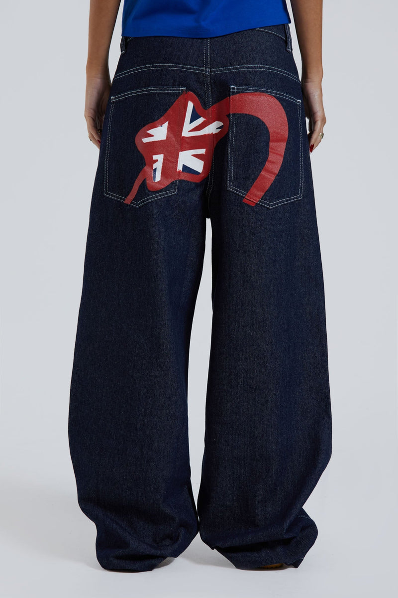 Female wearing sandblast washed denim jeans in an oversized skate fit with embroidered coin pocket and Union Jack artwork across back body and pockets. 