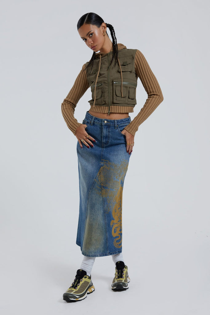Female wearing sandblast washed denim 00's style maxi skirt with dragon flock print. 