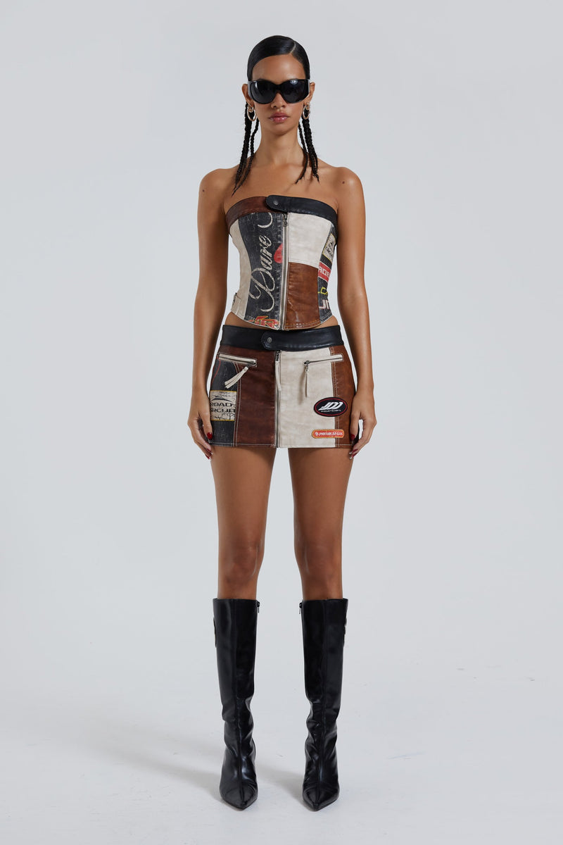 Female wearing moto PU panelled corset style bandeau top with dipped hem detail. Styled with the matching mini skirt.  