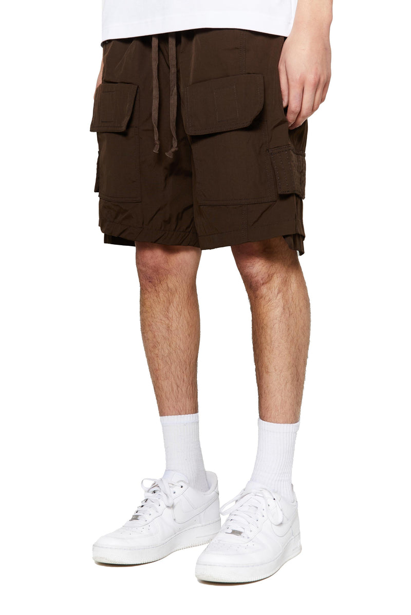 Brown oversized cargo shorts in relaxed fit with ten pocket styling detail. 