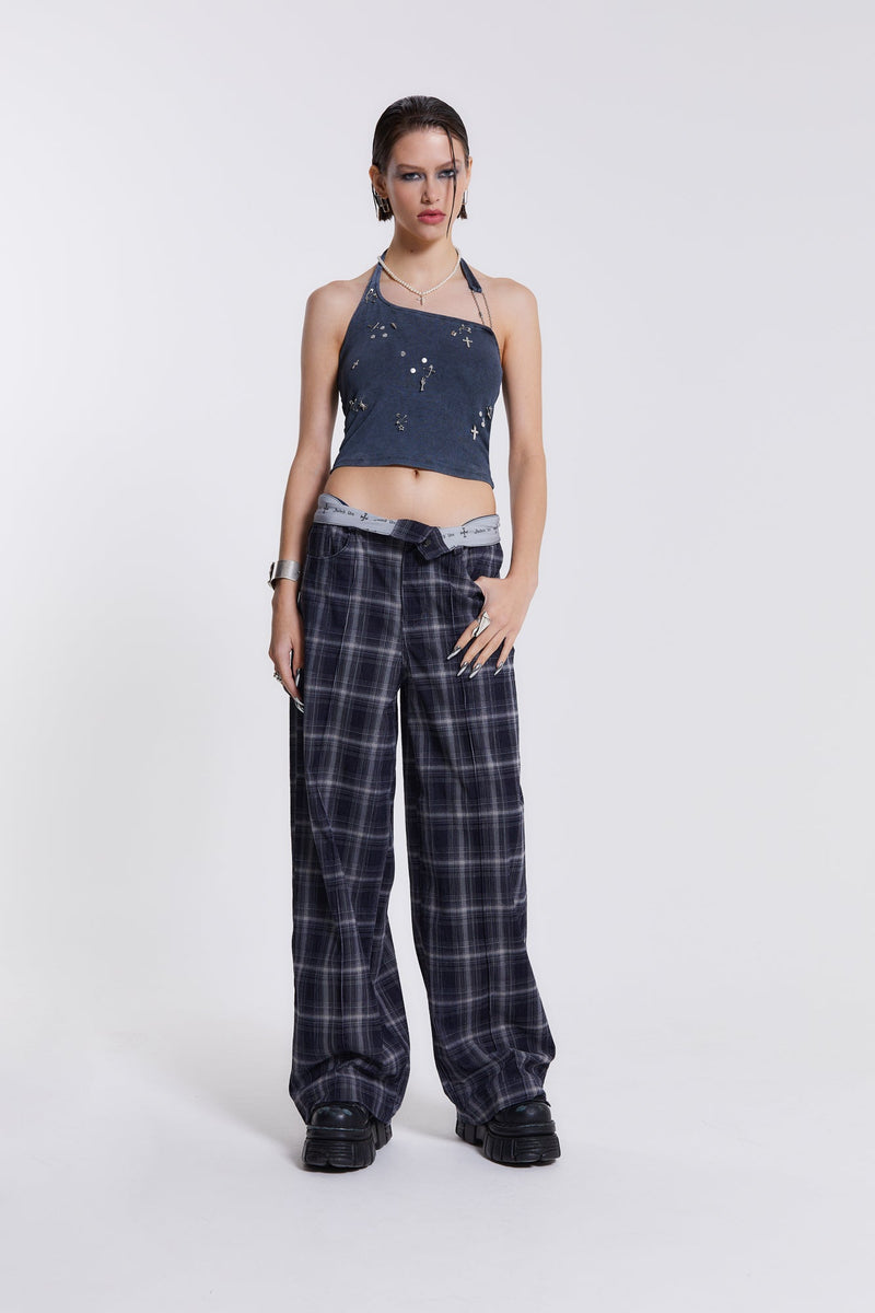 Female model wearing wide leg blue and white checked trousers with a fold over waist detail. Paired with blue denim top.