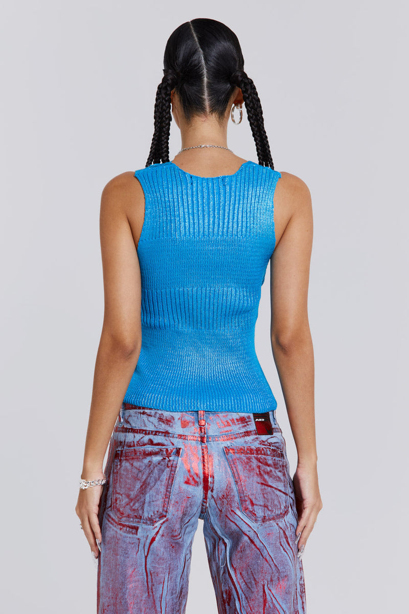 Female wearing blue metallic knitted v-neck sliced top. Styled with blue and red metallic distressed jeans. 