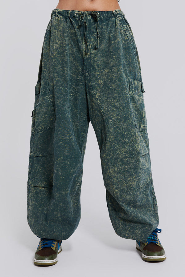 Female wearing green acid wash parachute cargo pants. 