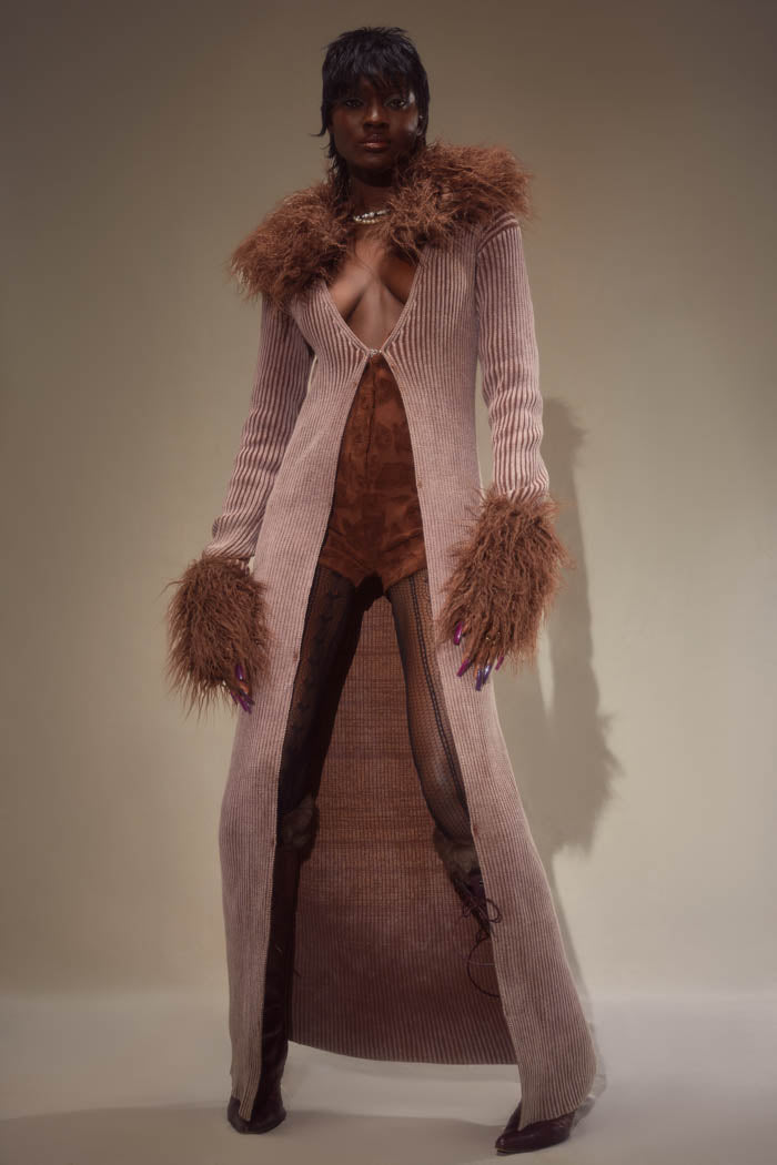 Chocolate brown ribbed knitted maxi length cardigan with detachable fur collar and cuffs. Styled with a brown long sleeve embossed romper playsuit. 